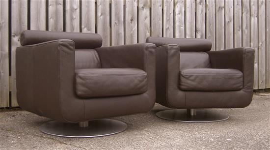 A pair of Natuzzi leather swivel armchairs W.77cm